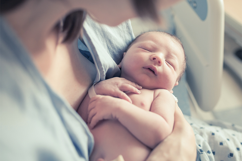 Parenting and new life concept. Mother holding newborn baby boy